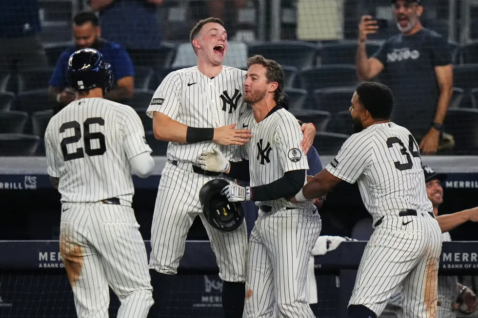 Yankees rally with 2 outs in 9th inning and beat Braves 3-2 in 10 after long rain delay