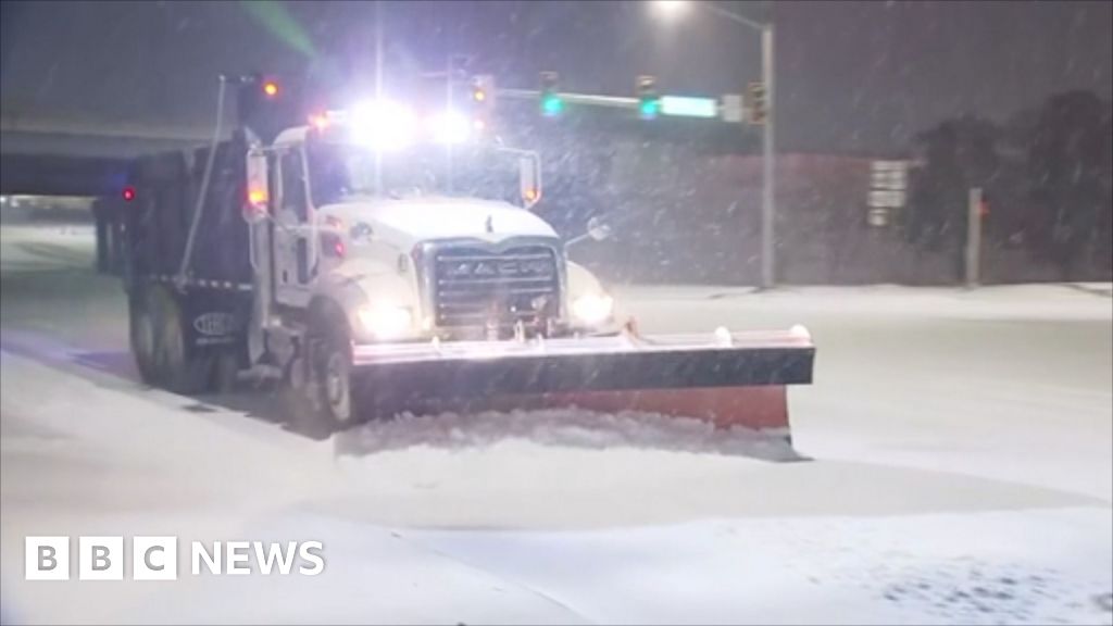 Snow ploughs battle blizzards on roads and runways in Oklahoma