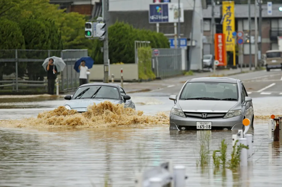 Heavy rain and flooding in north-central Japan strands people and vehicles