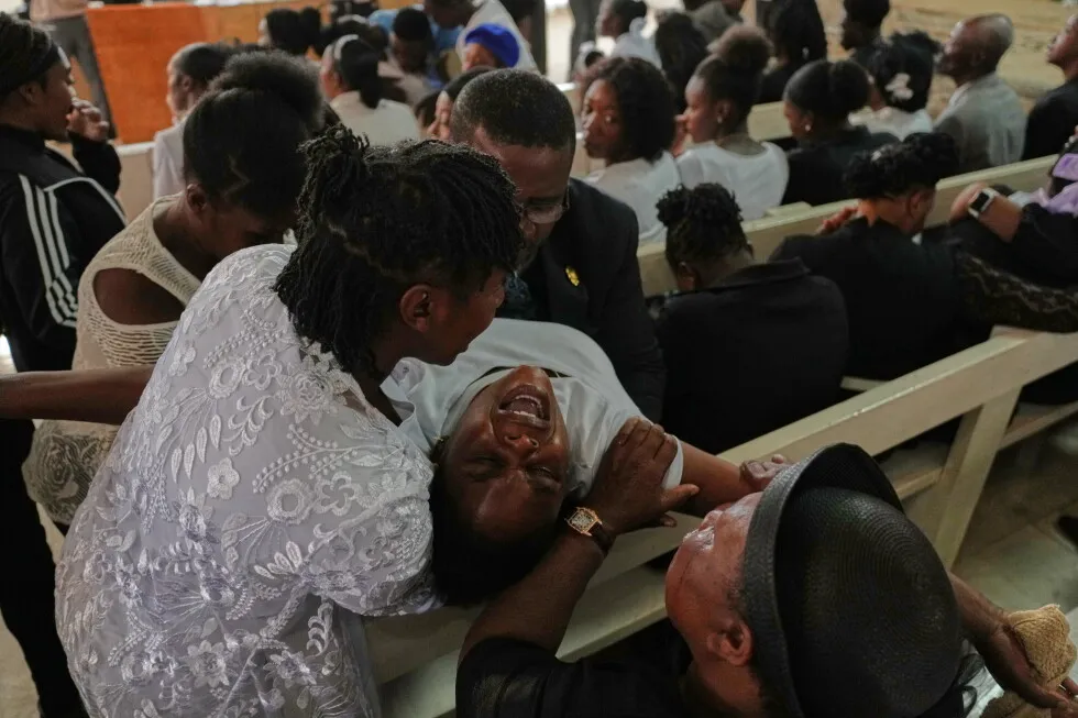 Mourners file into a church in Haiti where gangs killed dozens of people in latest rampage