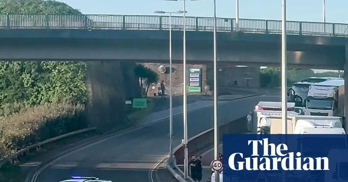 Black-clad protesters in balaclavas block road at port of Dover in Kent
