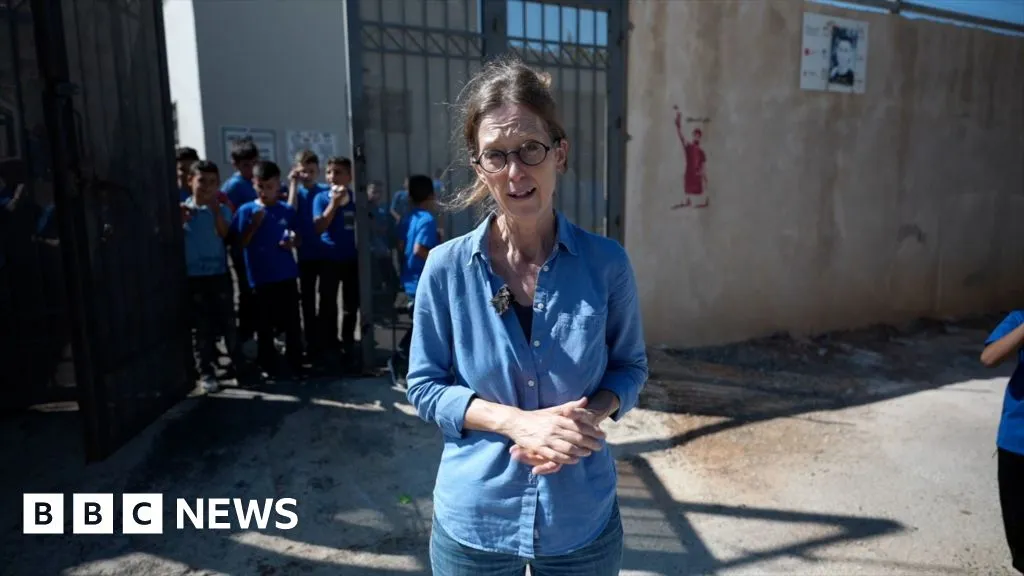Pupils return to West Bank school behind barbed wire to protect against settlers