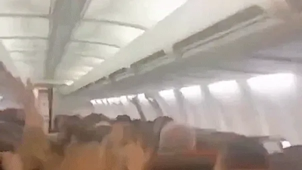 Plane passengers scream in harrowing mid-flight video as violent shaking sends cabin ceiling panels flying