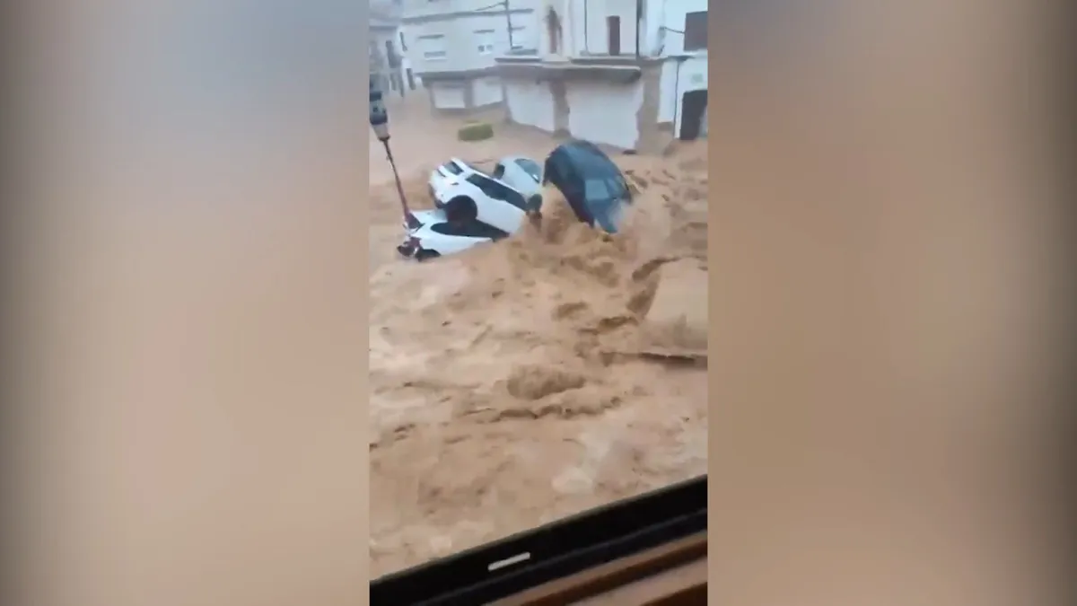Floods sweep cars through streets after intense rain in Spain