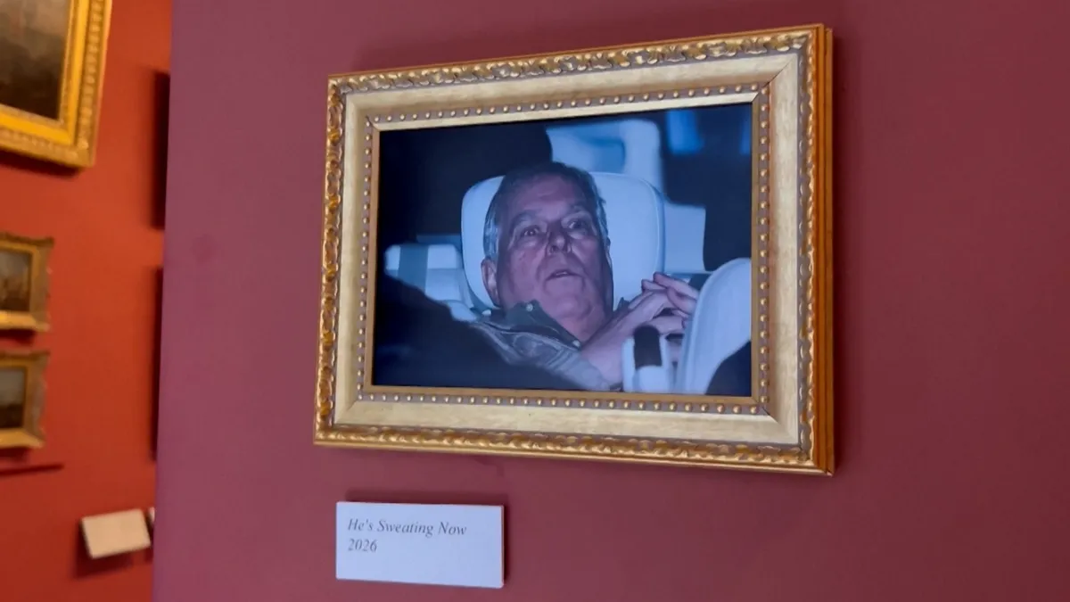 Activists hang Andrew arrest photo at Louvre Museum