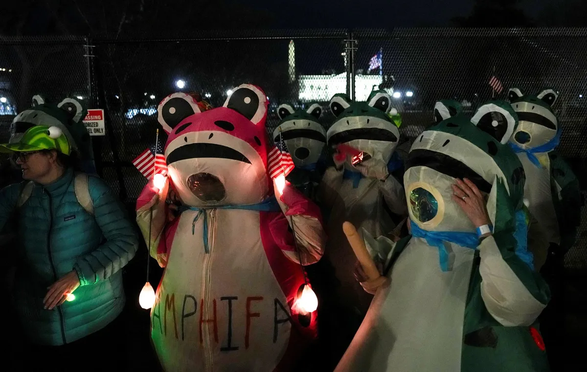 Demonstrators in frog costumes protest Trump’s State of the Union