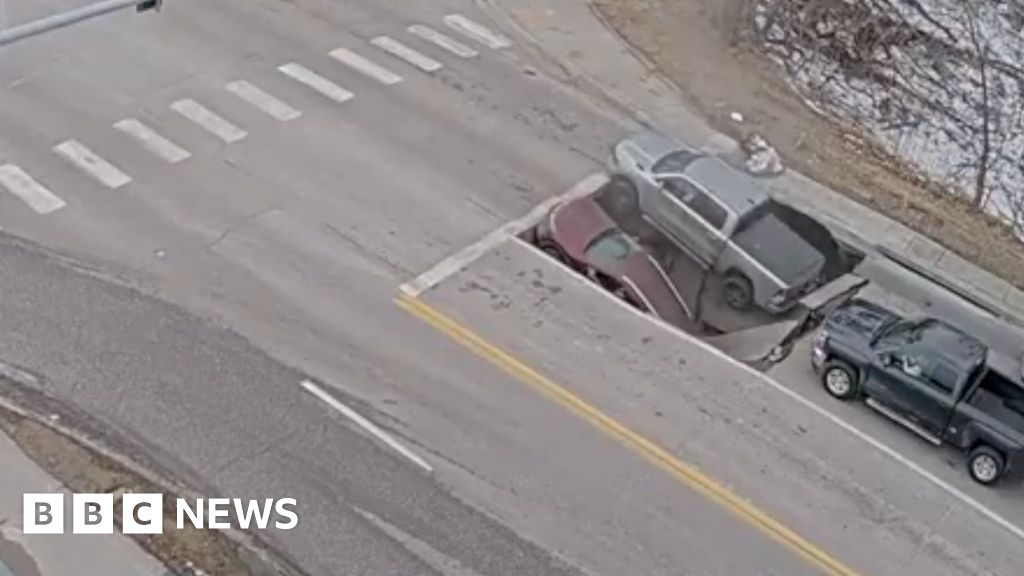 Watch: Moment a sinkhole in Omaha traps cars and drivers