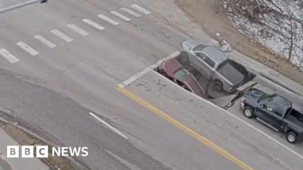 Watch: Moment a sinkhole in Omaha traps cars and drivers