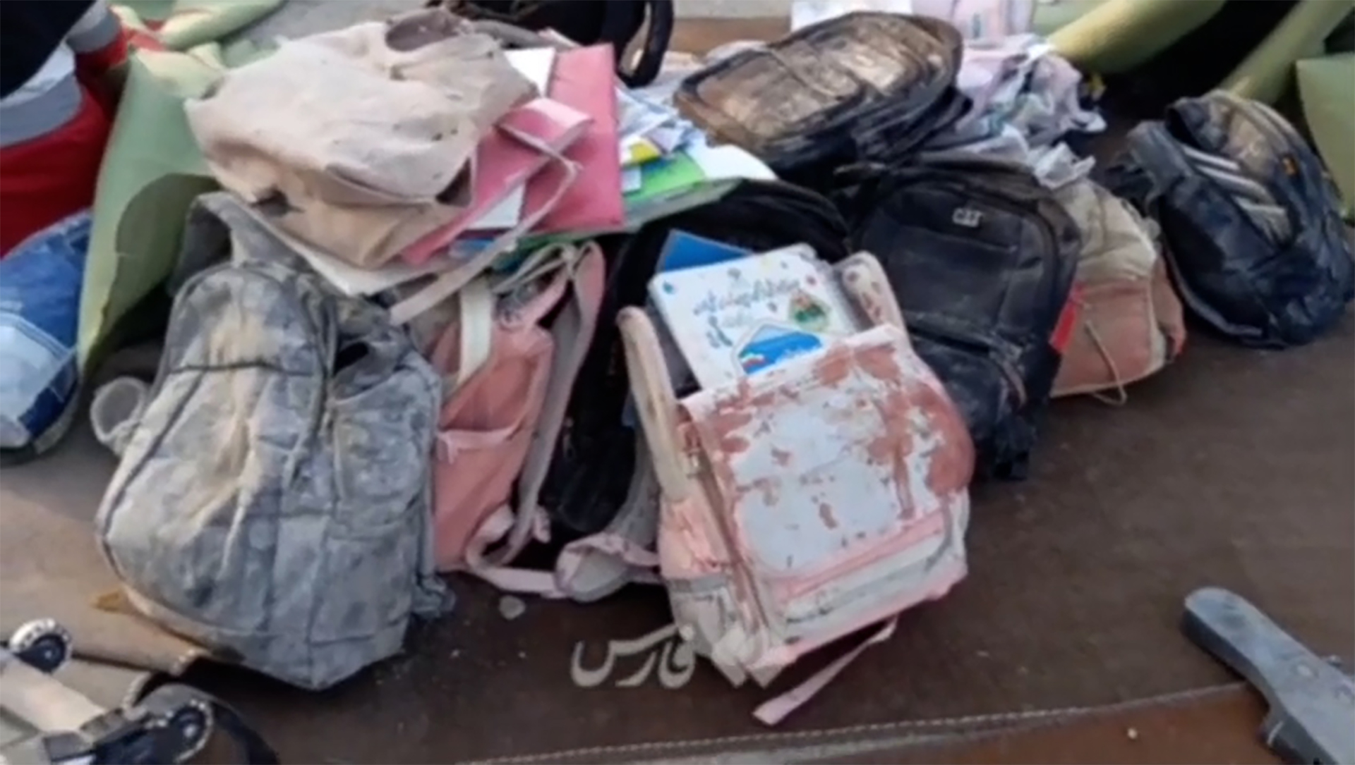 Backpacks, schoolbooks seen amid rubble of Iranian girls’ school