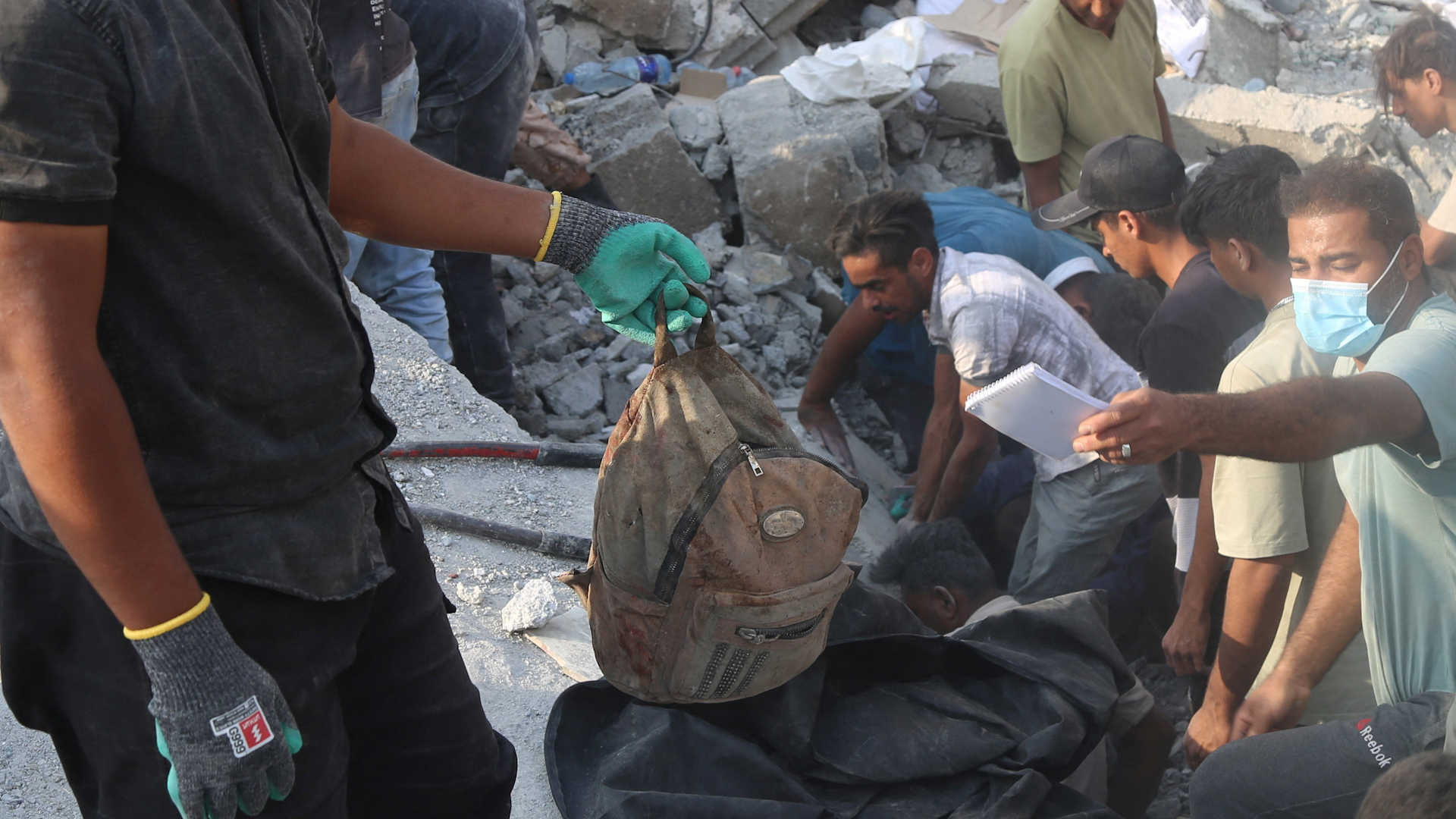 Man accuses Israel of war crimes as he holds remains of girl killed in Iran