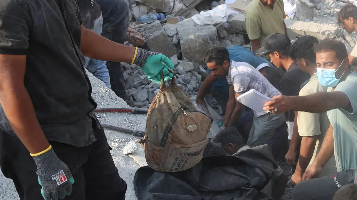 Man accuses Israel of war crimes as he holds remains of girl killed in Iran