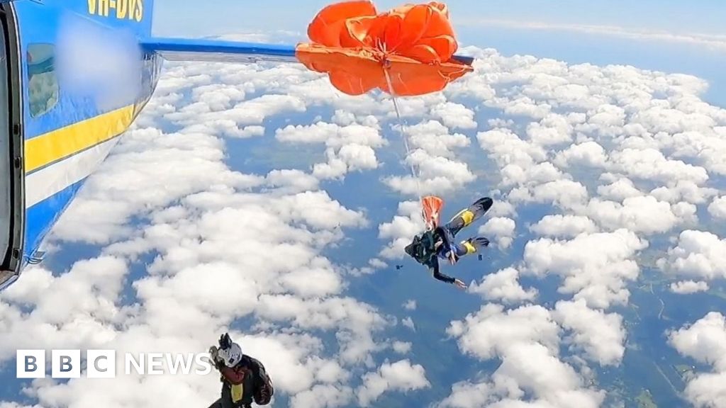 Moment skydiver's parachute wraps around plane wing