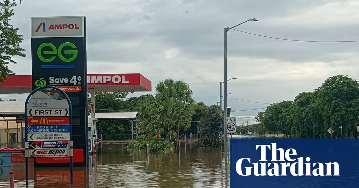 ‘A saltwater crocodile on the AFL oval’: worst flooding in decades inundates the NT as residents urged to avoid water