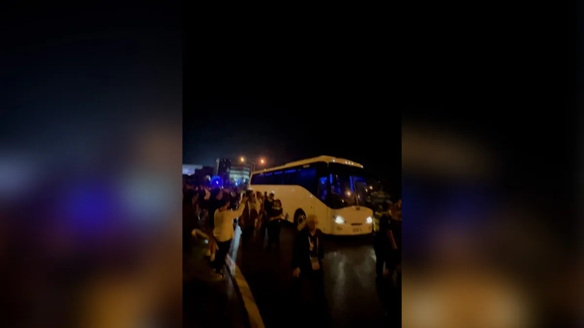 Crowd chants ‘save our girls’ at bus carrying Iran women’s team