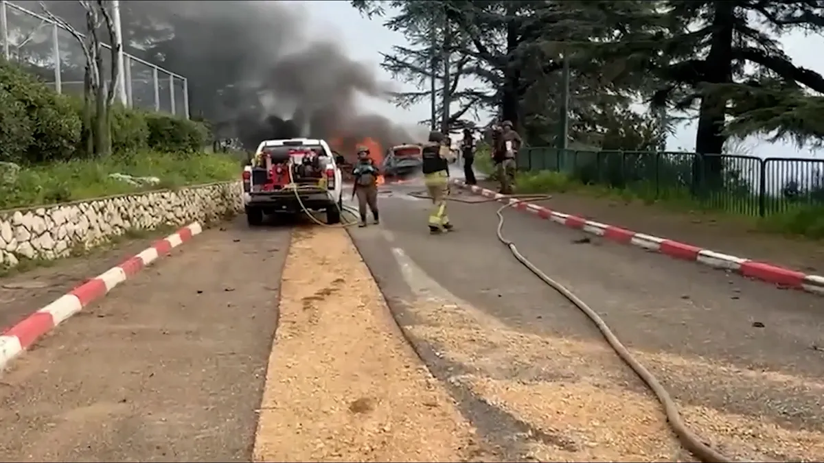 Israeli firefighters battle vehicles blaze after missile attack from Lebano