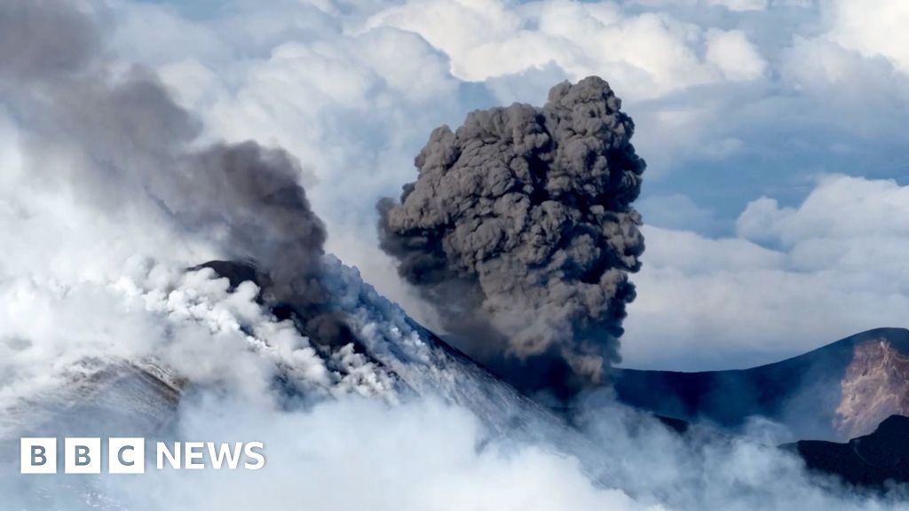 Snow-capped Mount Etna erupts as skiers glide down slopes