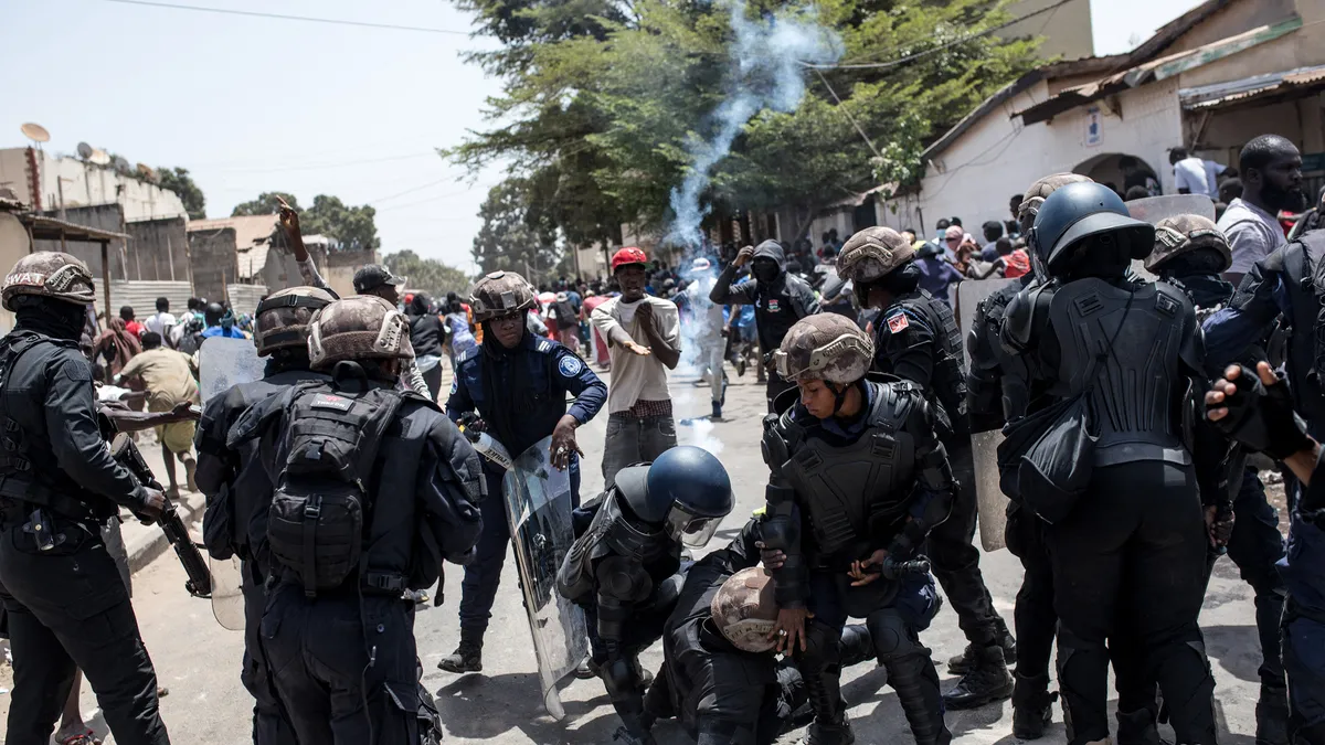 Gambia police fire tear gas at rally over rearrest of siblings