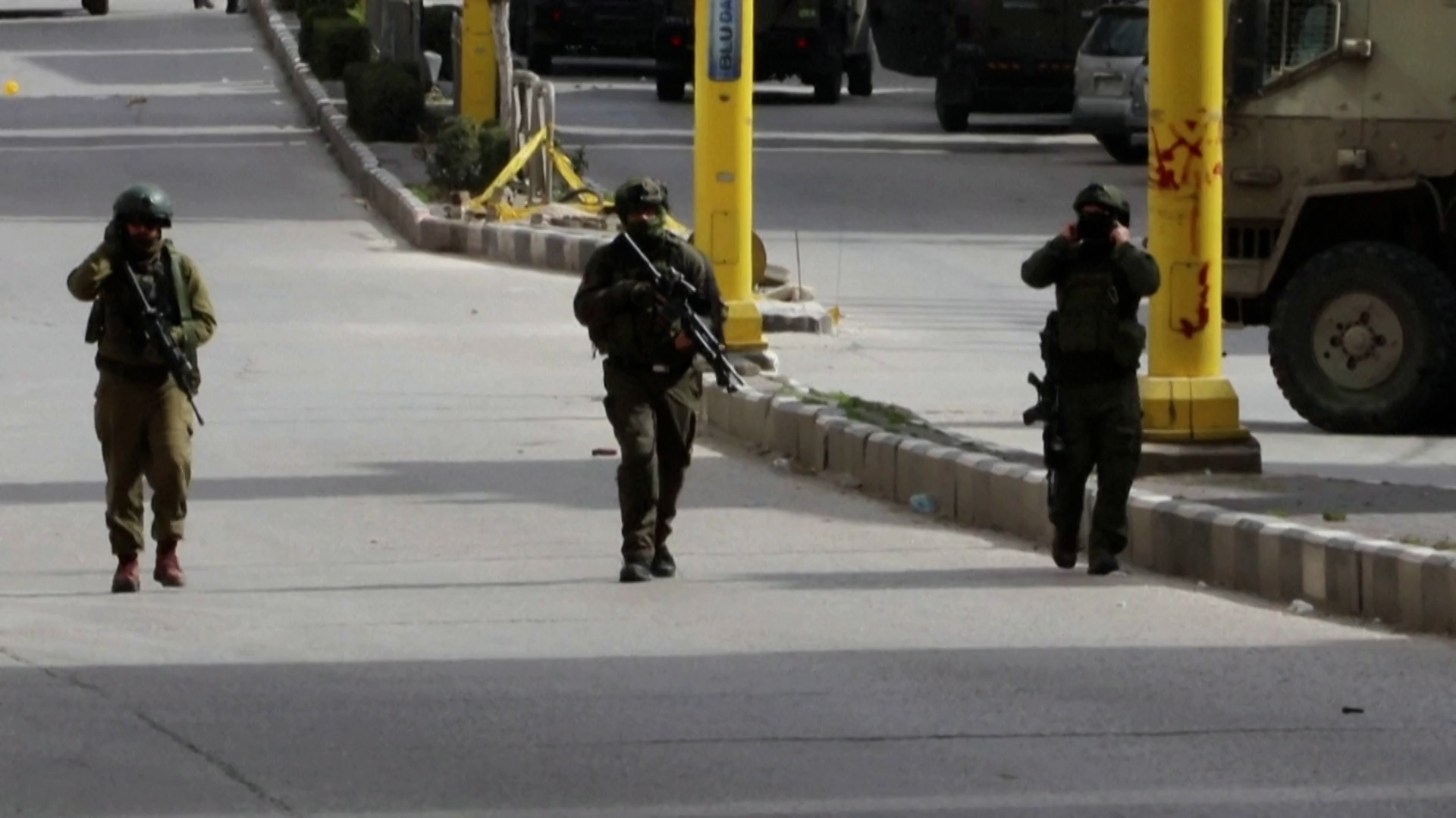 Israeli soldiers fire tear gas at Palestinian youth during raid in Hebron