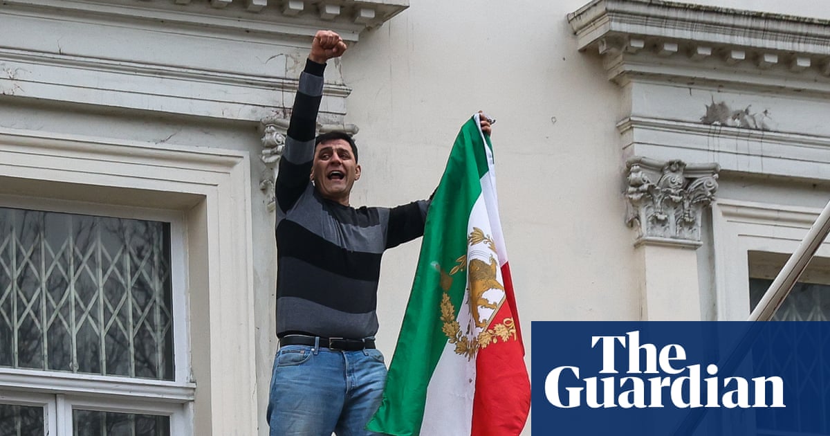 Protester pulls down national flag from Iranian embassy in London