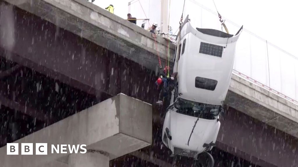 Watch: Driver hoisted to safety from truck dangling over West Virginia bridge