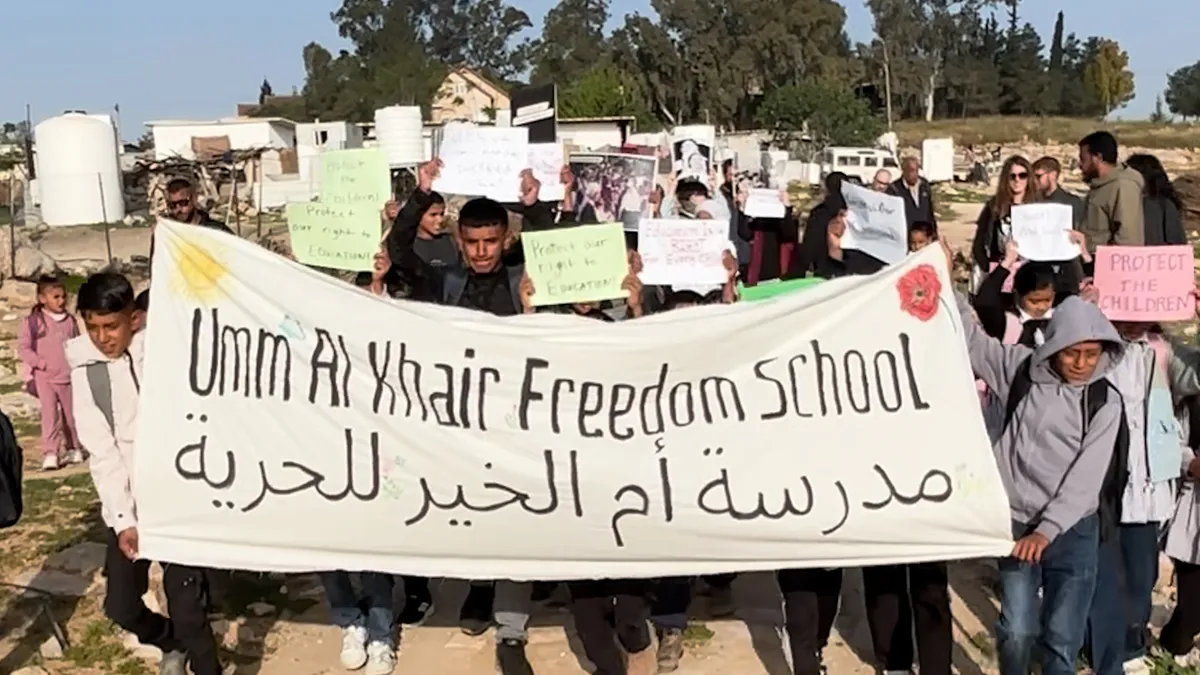 Palestinian children protest against siege on their school