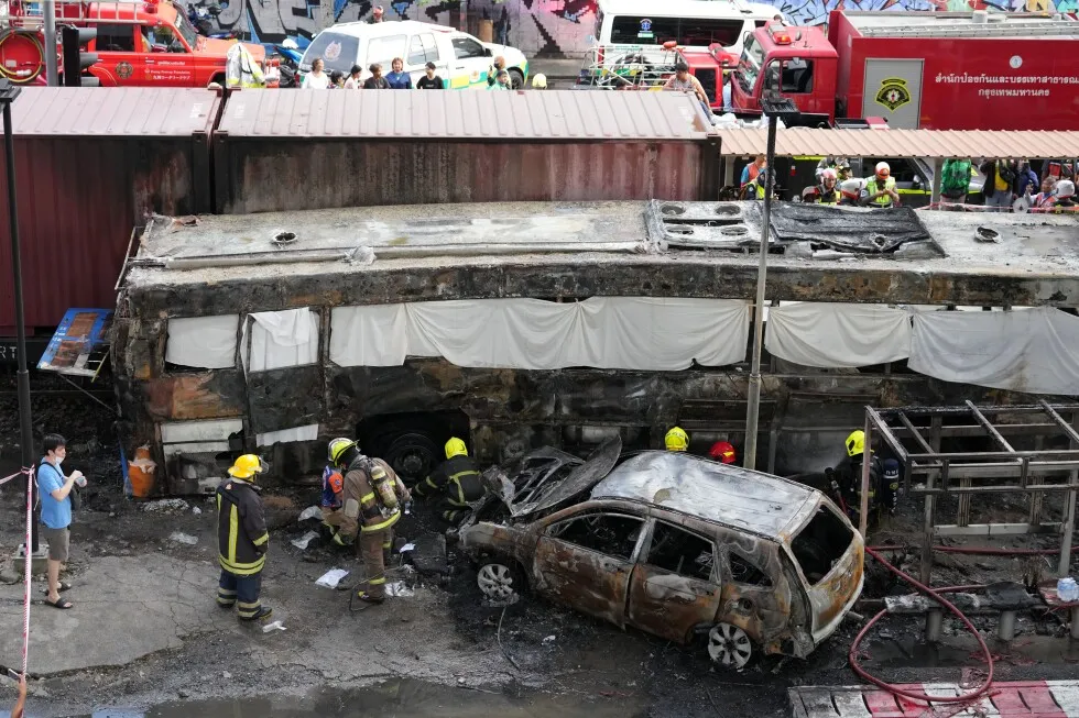 A cargo train hits a public bus at a Bangkok rail crossing, killing at least 8