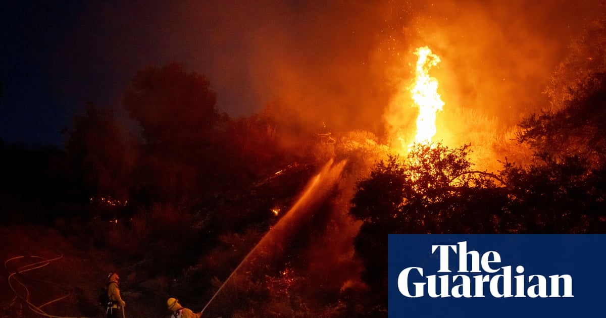 Thousands under evacuation orders in southern California as wildfire threatens homes