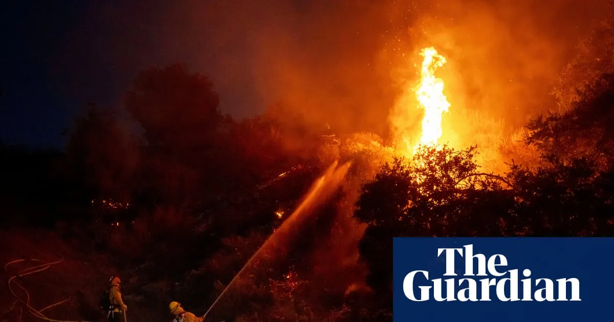 Thousands under evacuation orders in southern California as wildfire threatens homes