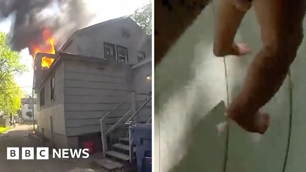 Police officer catches baby dropped from window of burning home