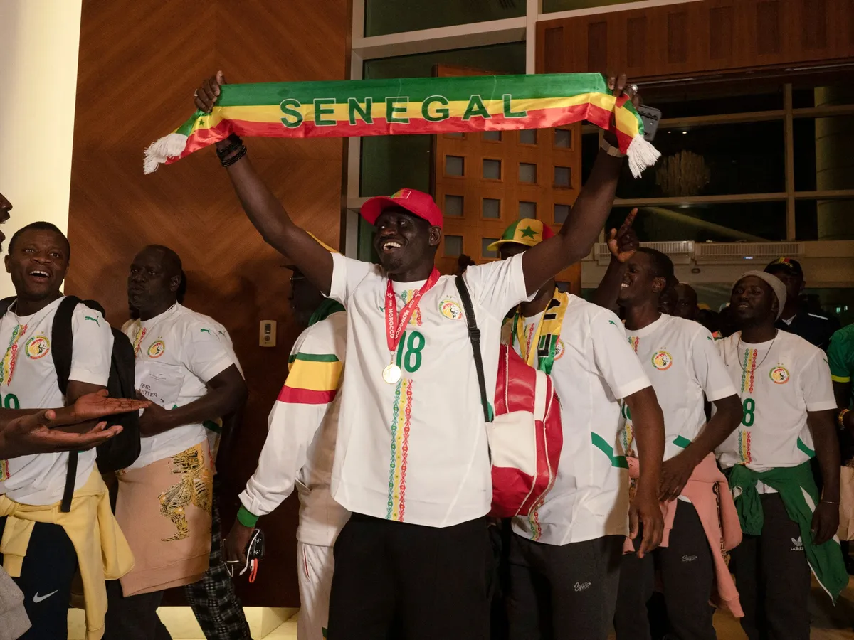Senegal football fans return home after royal pardon in Morocco