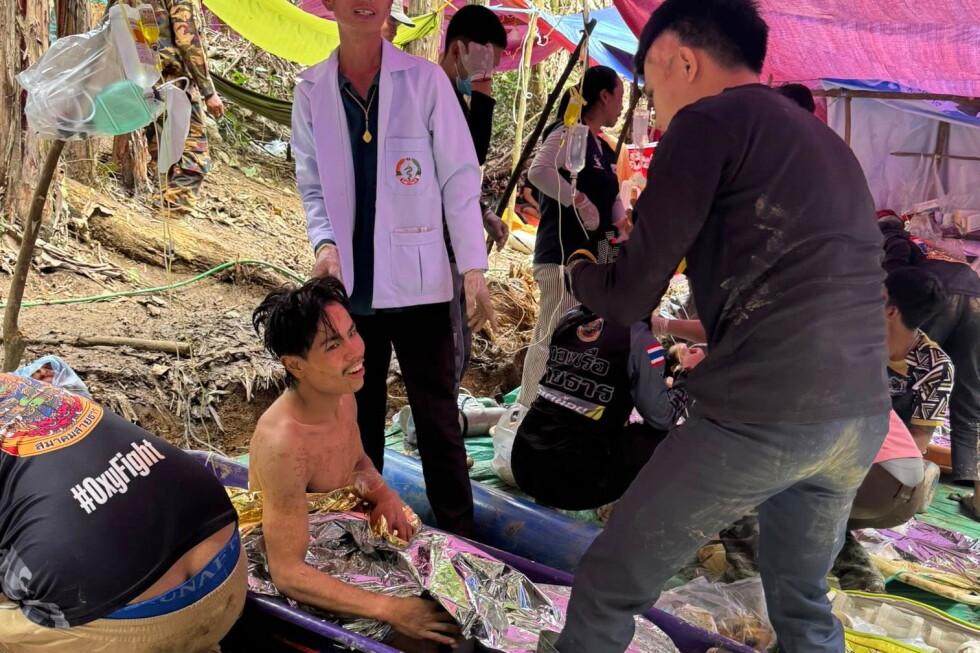 Rescuers free 4 men who had been trapped in a flooded Laos cave, search for 2 still missing