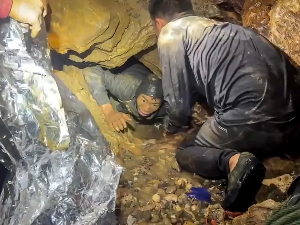 Rescuers race to save two people still trapped in cave in Laos