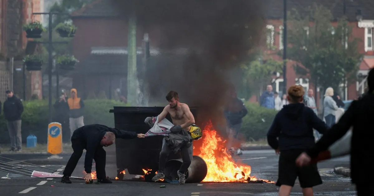 Protesters torch cars, buildings in Belfast after refugee knife attack
