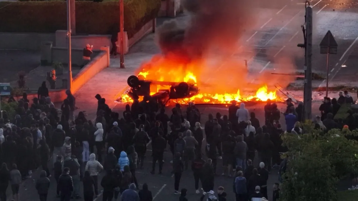 Anti-immigrant protesters clash with police, torch car at Belfast rally
