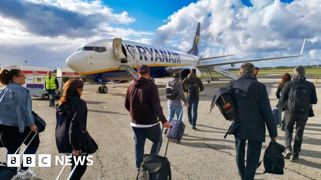 Ryanair 'reluctantly' agrees to let parents sit with children for free