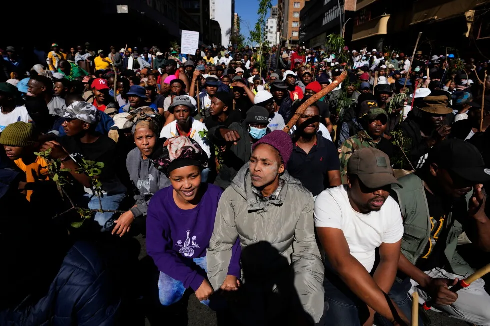 Anti-immigration protesters march in South Africa, as some immigrants leave the country