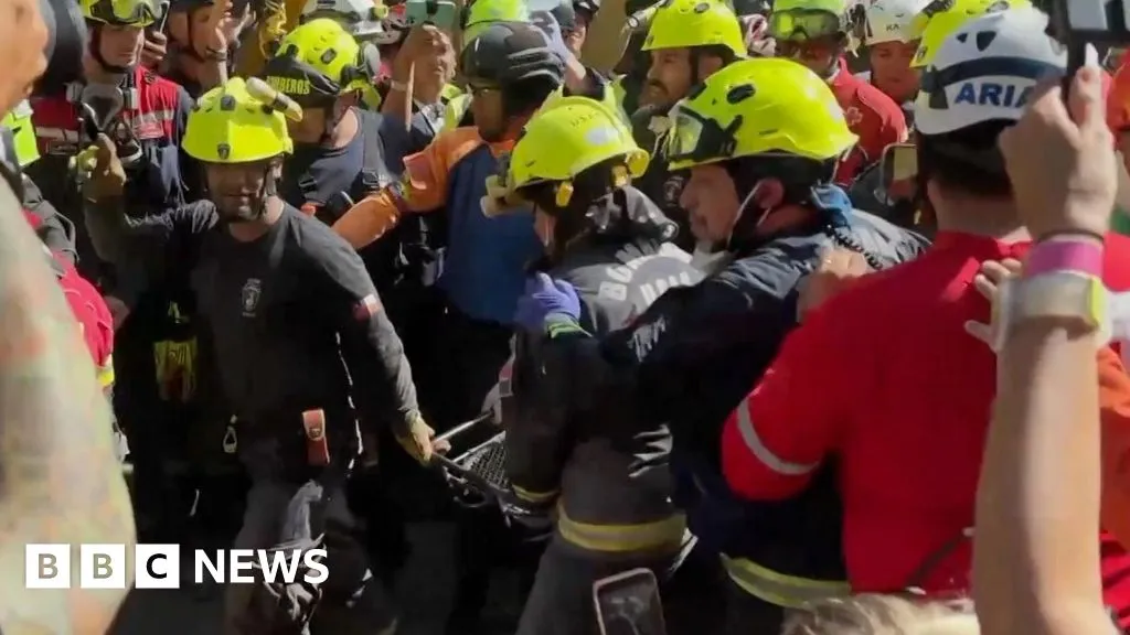 Cheers and applause as security guard rescued from rubble