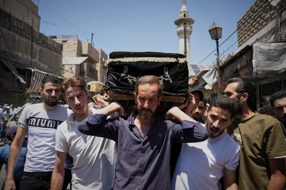 Mourners in Damascus bury cafe blast victims as officials promise justice