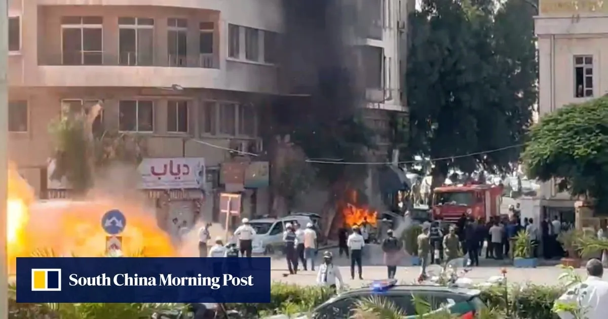 Explosions rock Damascus as France’s Macron visits Syria