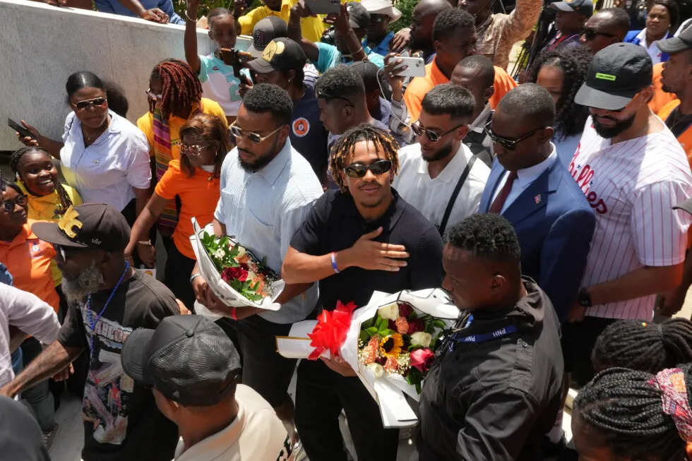 Members of Haiti’s national soccer team tour their capital after playing in the World Cup