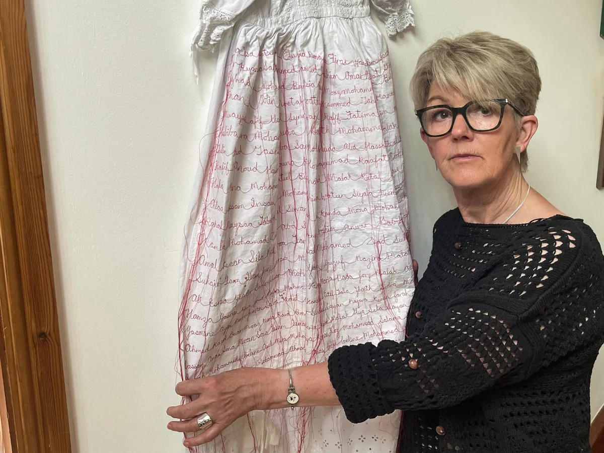 In Wales, an artist sews names of Gaza’s infant victims on christening gown