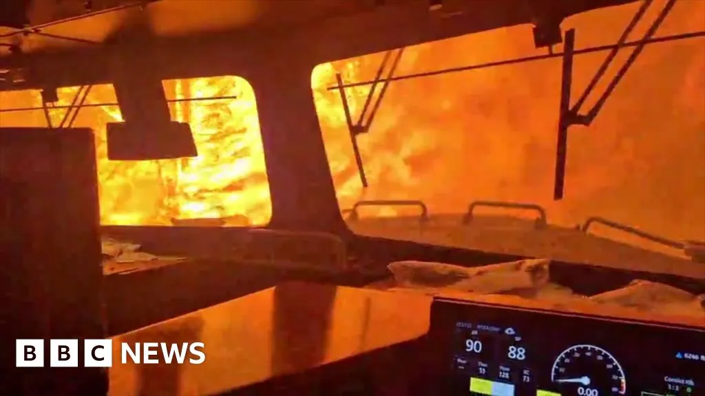 Dramatic video shows wildfire surround freight train in Canada