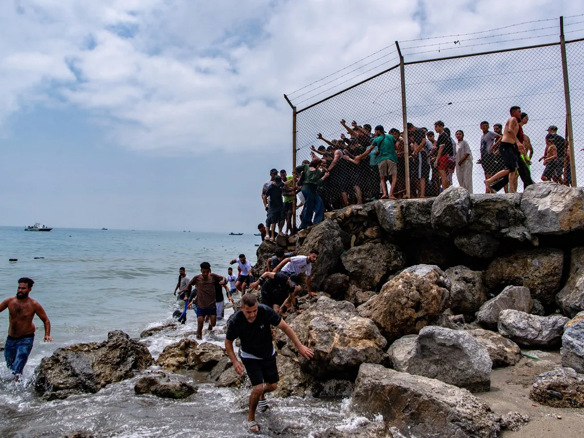 Spain’s enclave Ceuta raises alarm as thousands cross border from Morocco