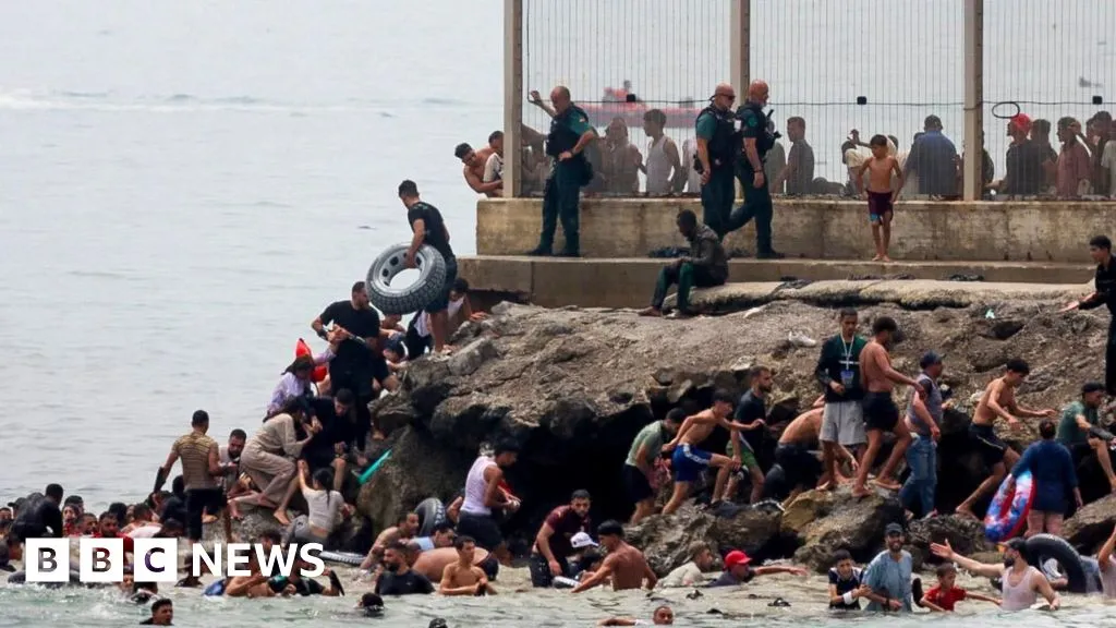 Hundreds of migrants swim from Morocco to Spanish enclave of Ceuta