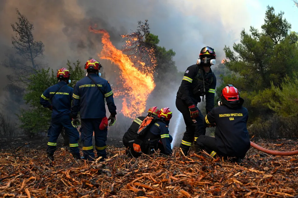 Firefighters scramble to contain fires outside Athens before winds and high temperatures return